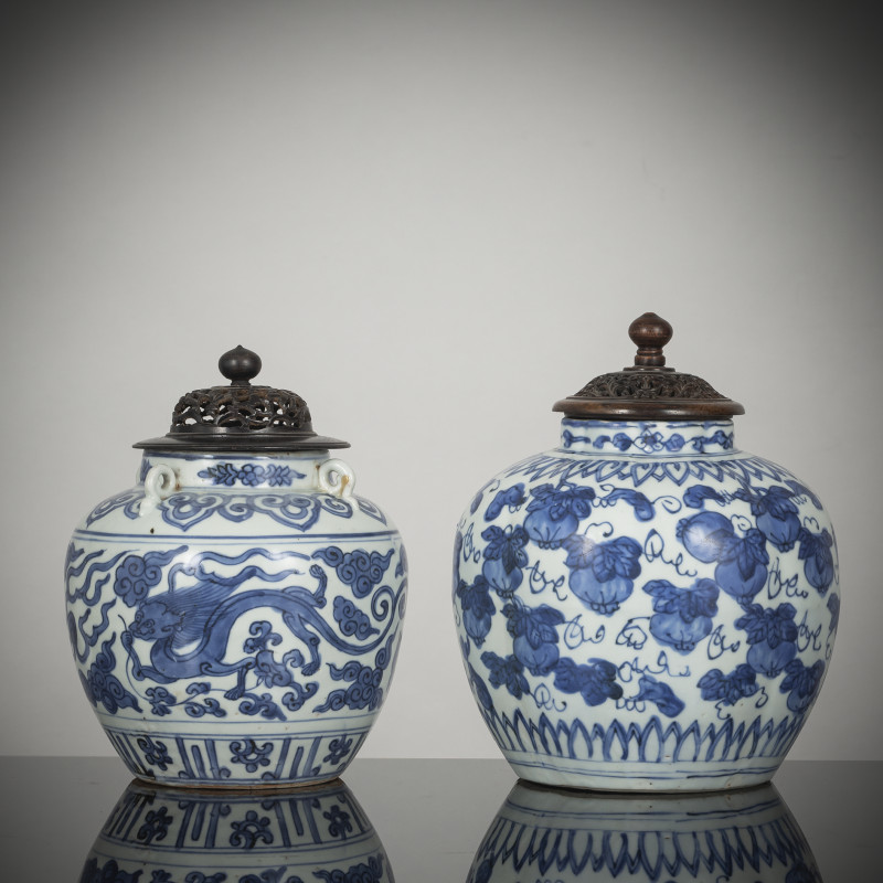 Two jars decorated with dragons or melons in underglaze blue with wooden covers