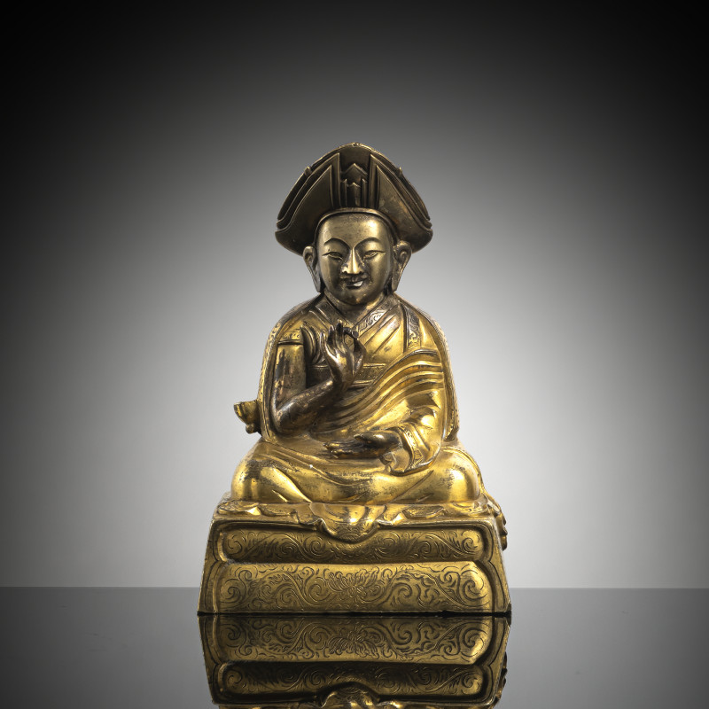 A parcel-gilt bronze figure of lama