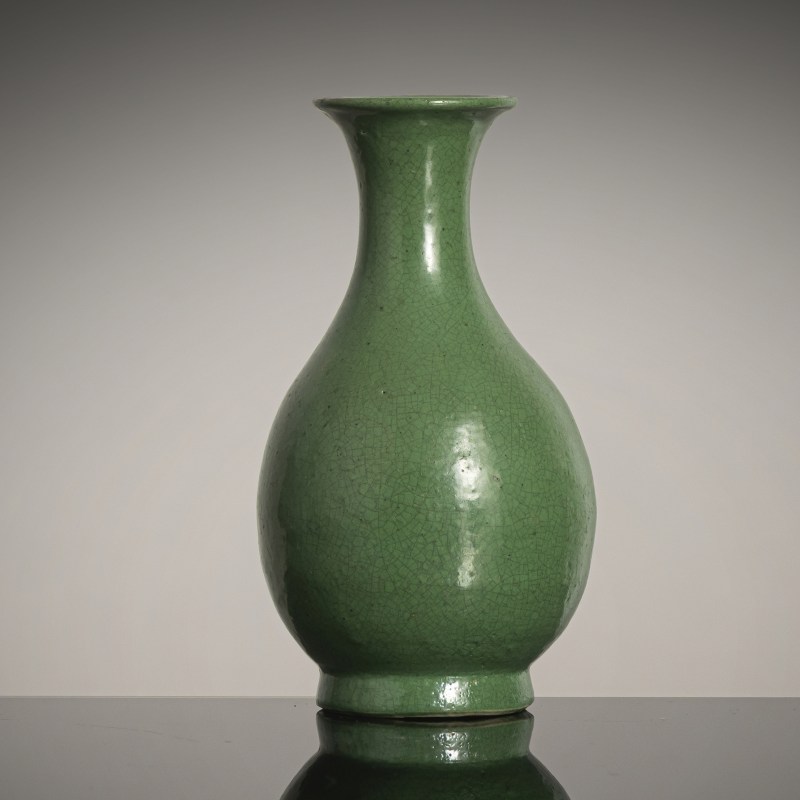 A small apple-green porcelain bottle vase