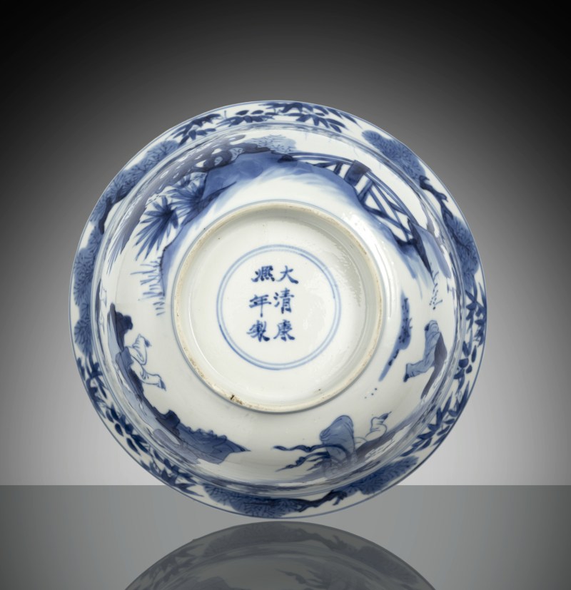 A blue and white porcelain bowl with decoration of ladies and boys in a garden landscape