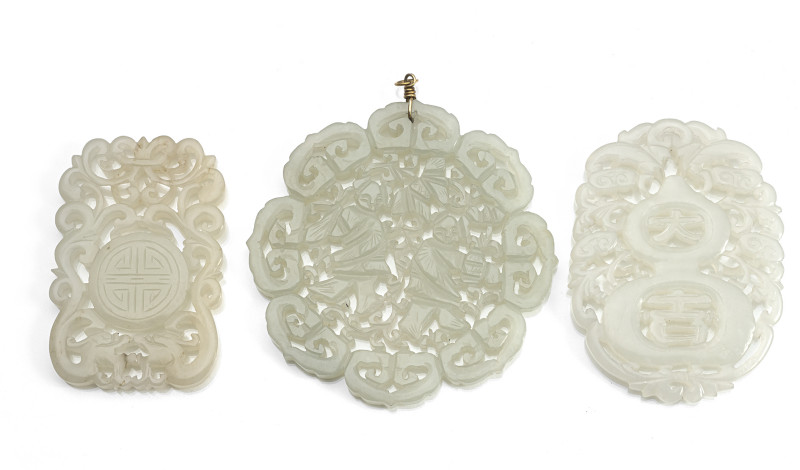 Three pendants made of jade, finely decorated in openwork with lucky symbols or the twin genii Hehe Erxiang'