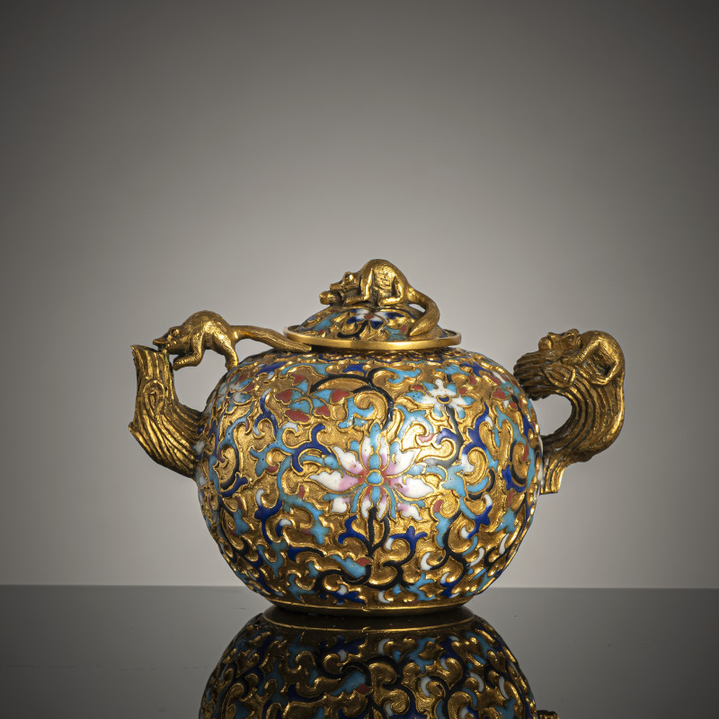 A fine gilt-bronze wine or teapot with champlevé decoration of lotus and foliage, the cover with a squirrel as knob