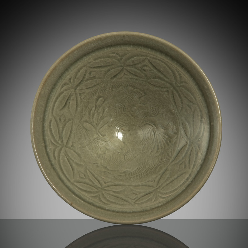 A conical 'Yaozhou' ware celadon bowl with carved decoration