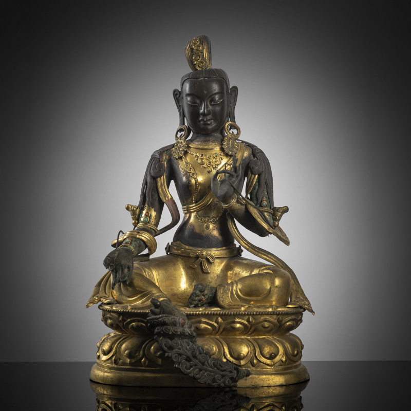 A PARCEL-GILT EMBOSSED COPPER FIGURE OF SYAMATARA