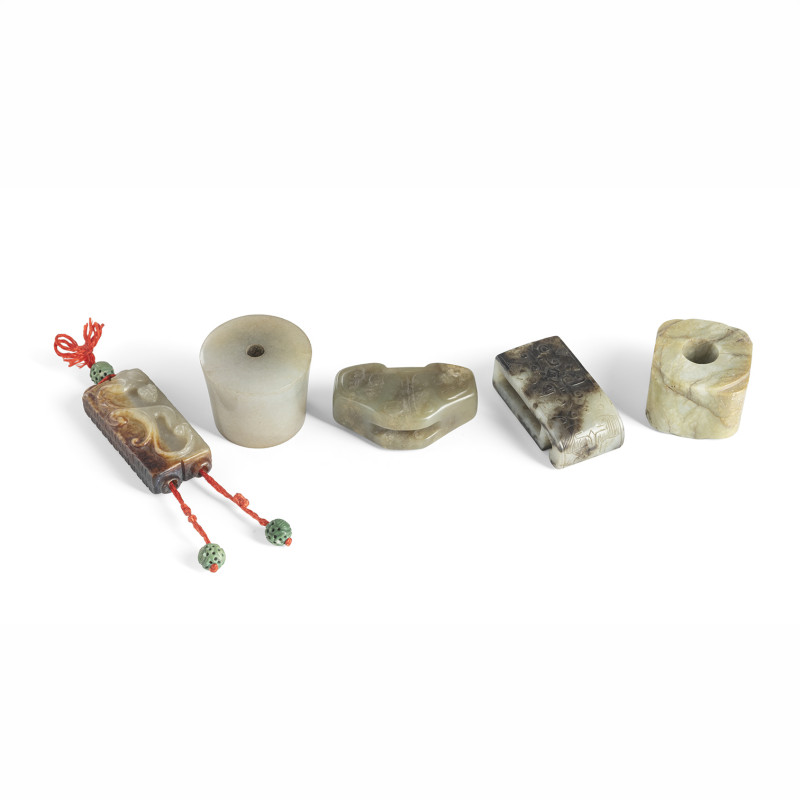 A group of jade p carvings, including the end of an opium pipe, various sword pendants, cong, etc.