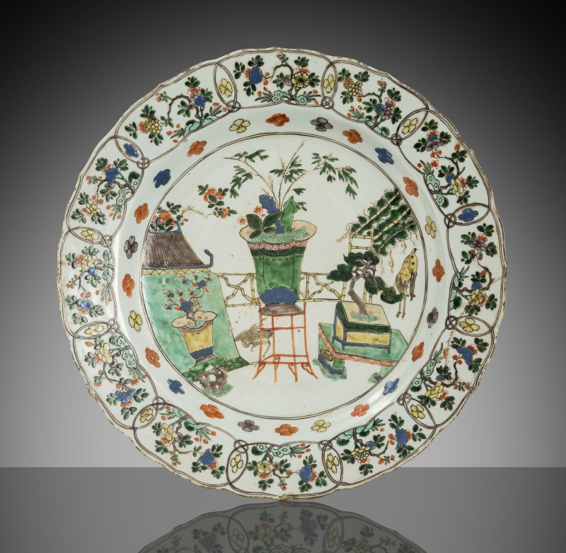 A large 'Famille verte' porcelain plate featuring ikebana arrangements and vases with flowers