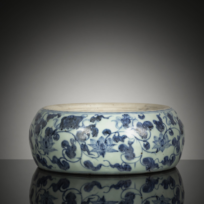 A porcelain inkstone with underglaze-blue decoration of lotus and foliage with Daoist treasures