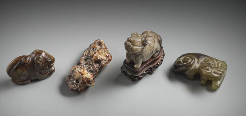 A group of four jade carvings, including mythical creatures and lions