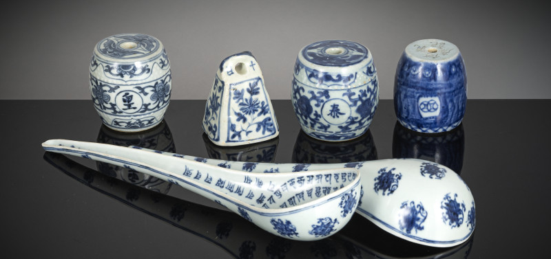 Four weights and two large porcelain spoons with underglaze blue lanca script decoration