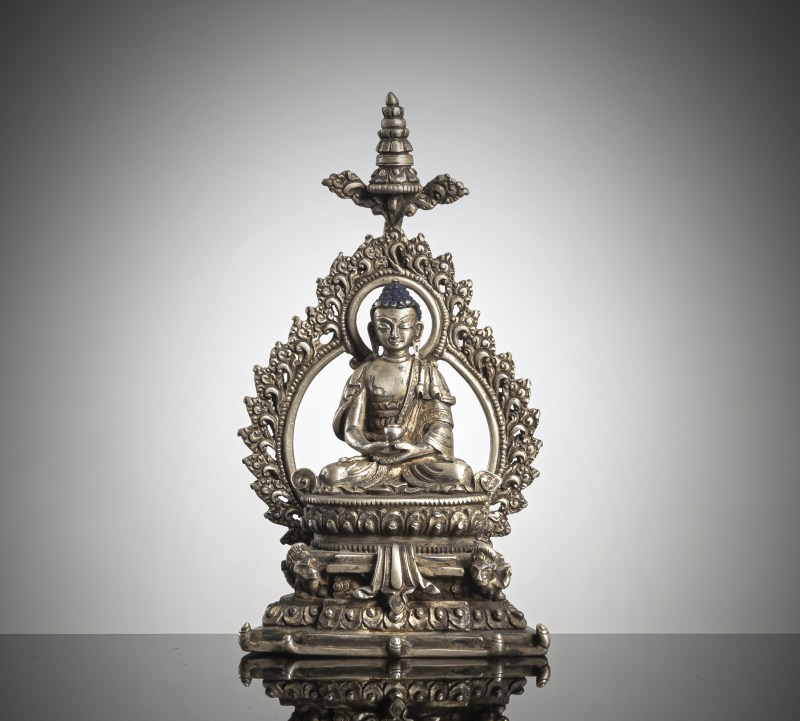 a silver figure of Buddha Shakyamuni