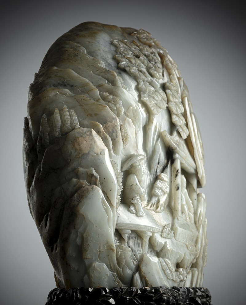 A large carved green jade boulder depicting scholars in a mountain landscape, mounted on a wooden stand - 图5