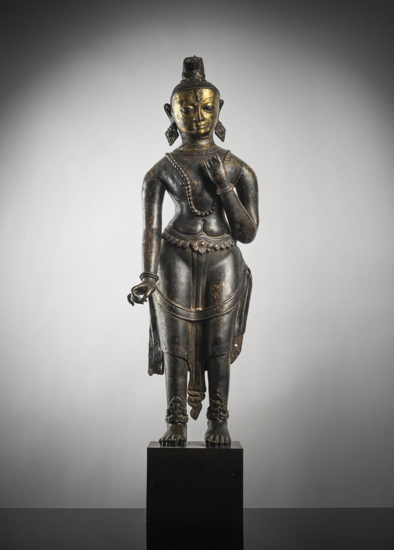 A large cast and repoussé figure of a standing deity