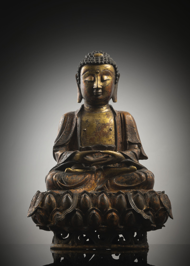 A GILT- AND RED-LACQUERED BRONZE FIGURE OF BUDDHA SHAKYAMUNI
