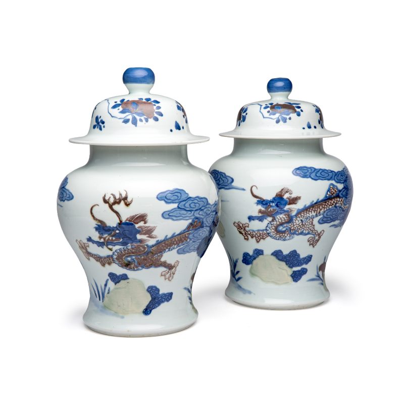 A pair of Chinese underglaze-blue, copper-red and celadon-glazed 'Dragon and Tiger' vases and covers - 图1