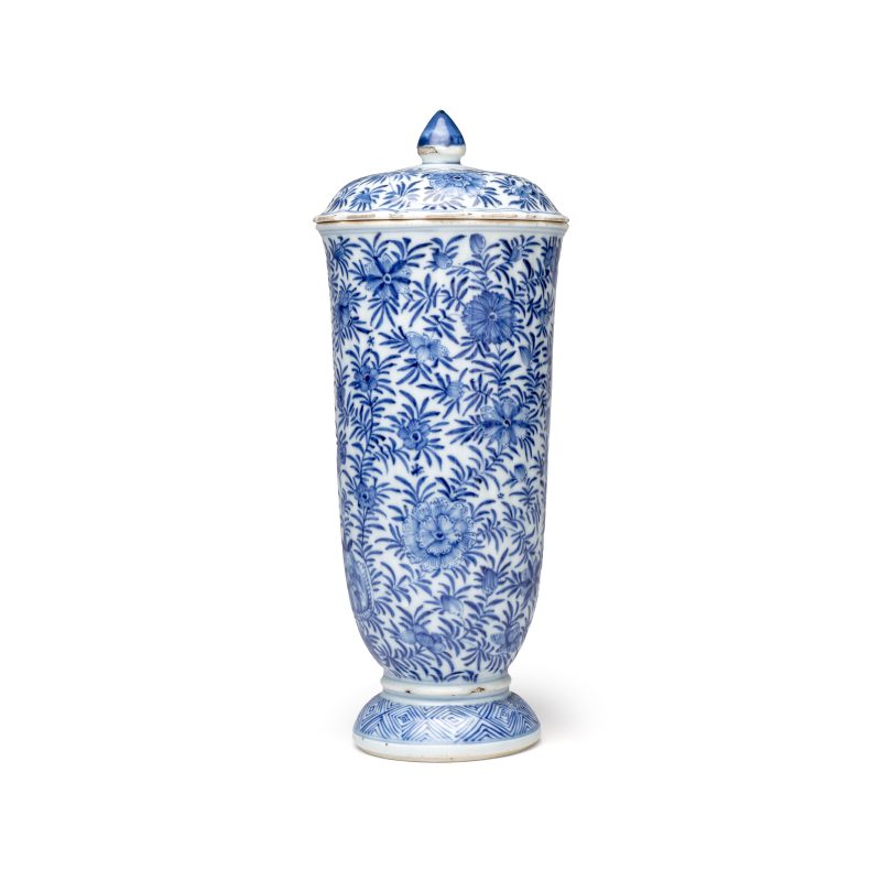 A Chinese blue and white beaker and cover with floral design