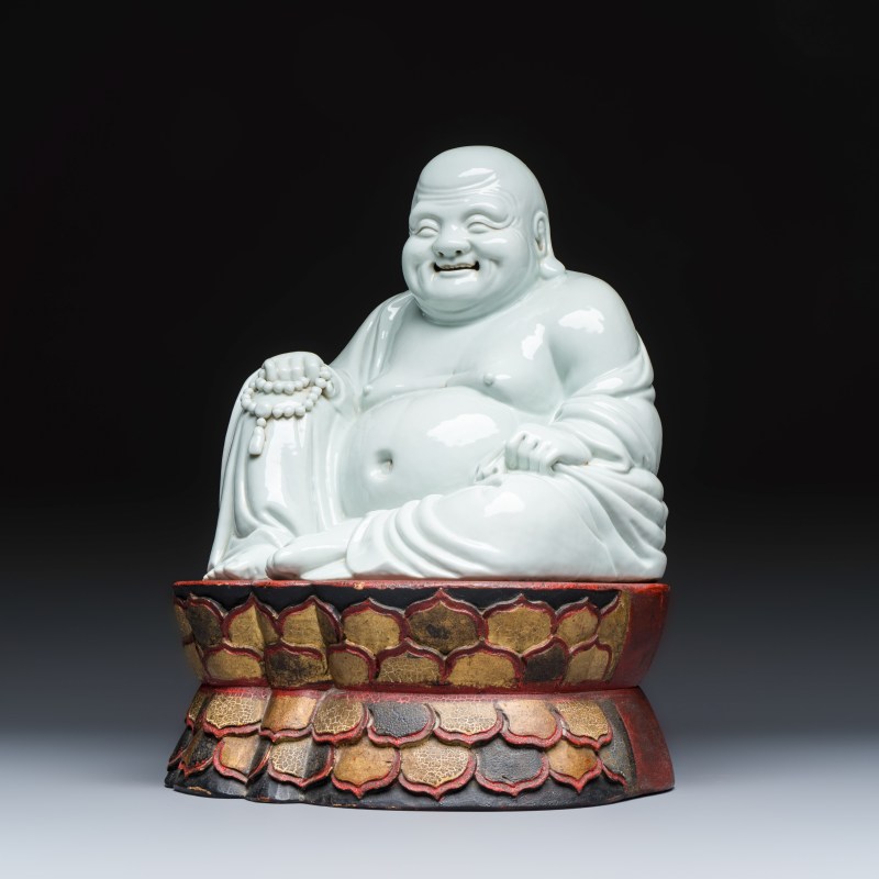 A Chinese white-glazed Milefo Buddha on a gilt-lacquered wooden lotus throne - 图1
