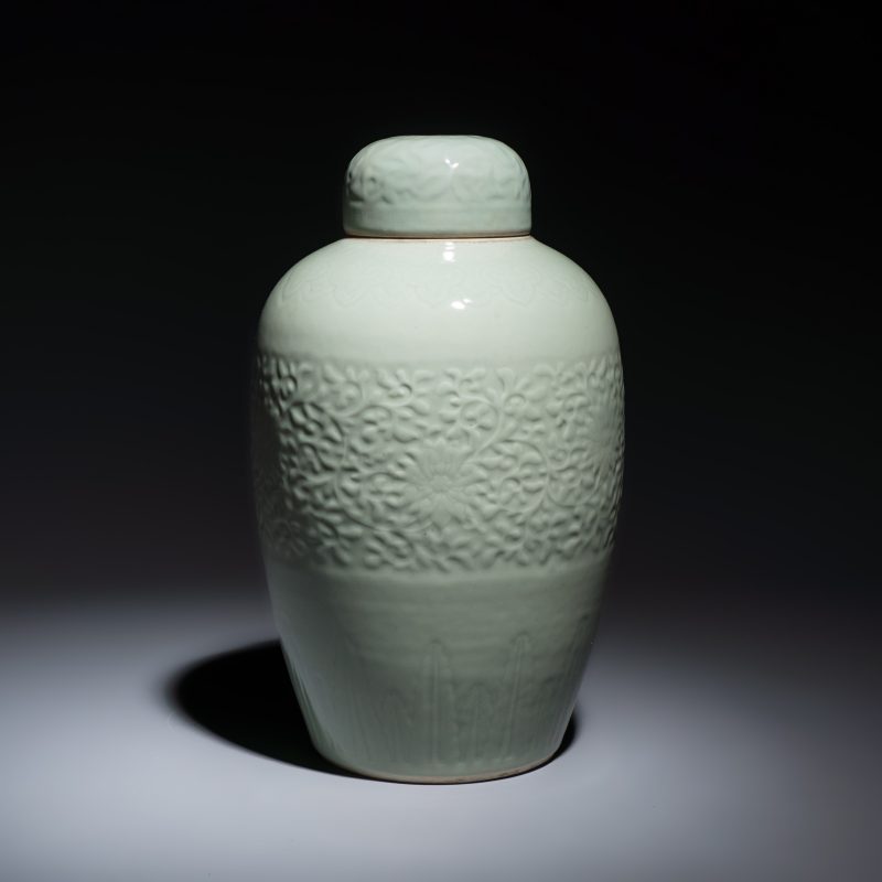 A Chinese celadon-glazed covered vase with floral relief design - 图2