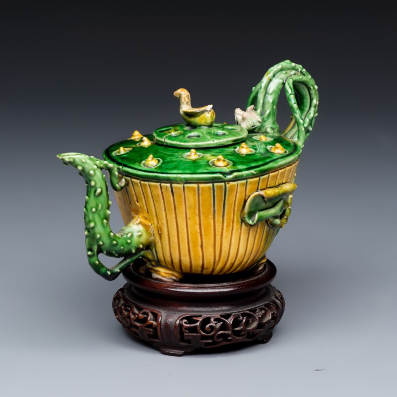 A Chinese famille verte sancai biscuit 'Lotus' teapot on a later wooden stand - 图1