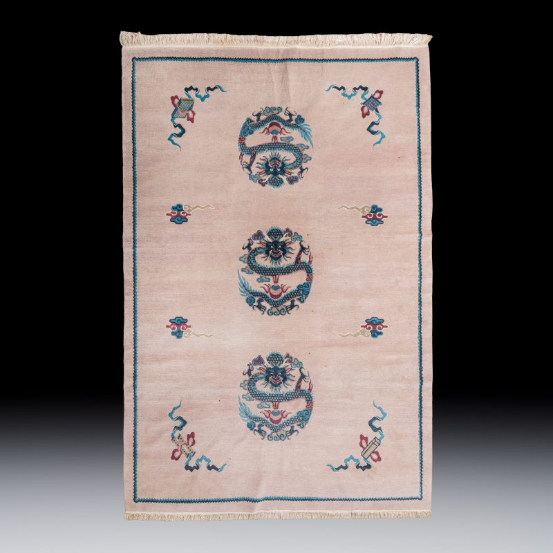 A large Chinese woollen pink-ground 'Dragon' carpet