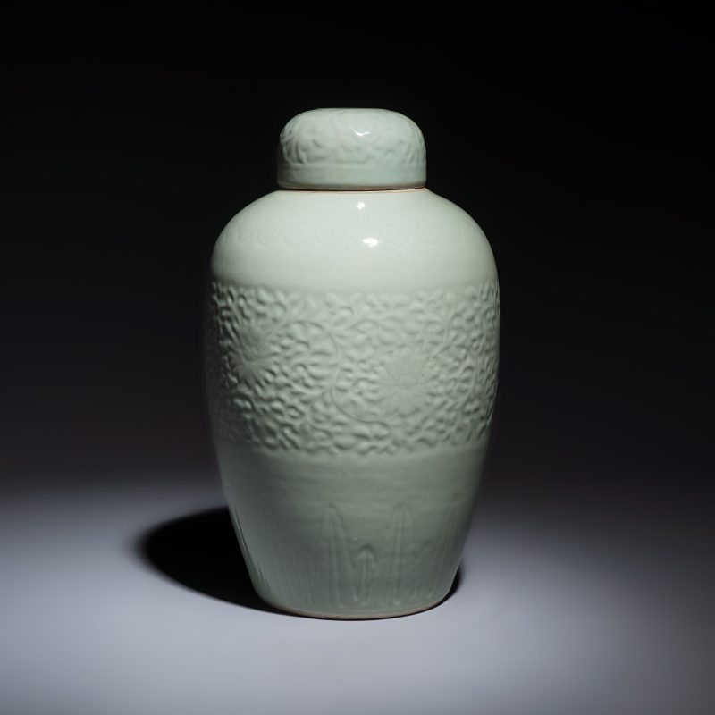 A Chinese celadon-glazed covered vase with floral relief design - 图4