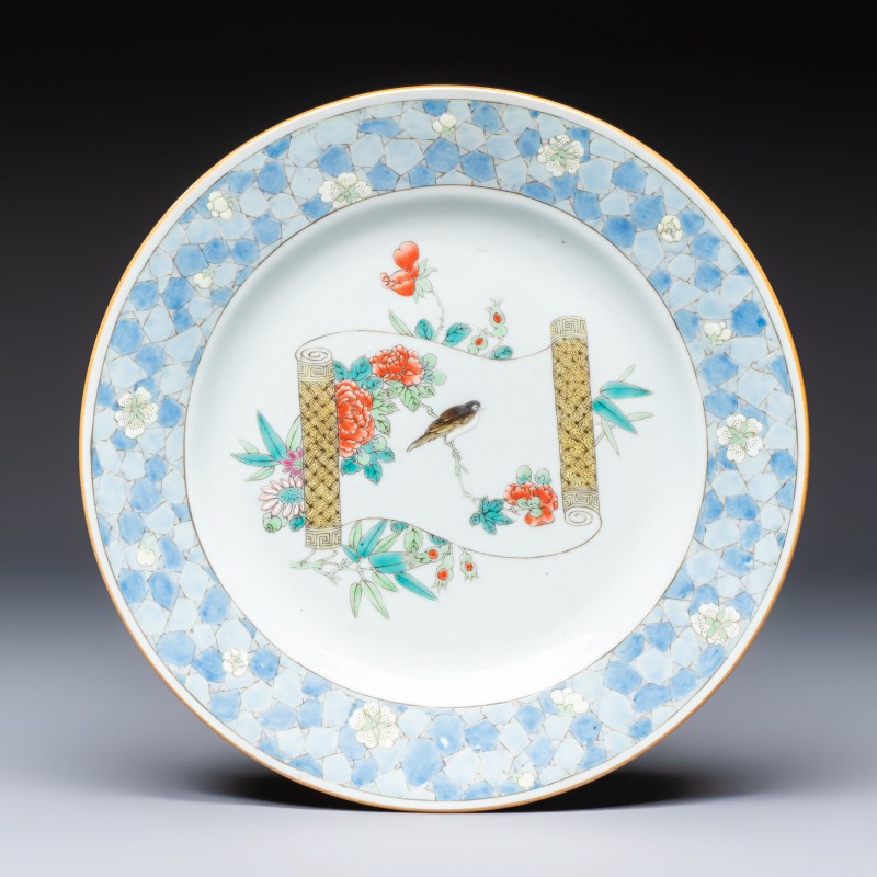 A Chinese famille rose ruby-back plate with a bird on a blossoming branch