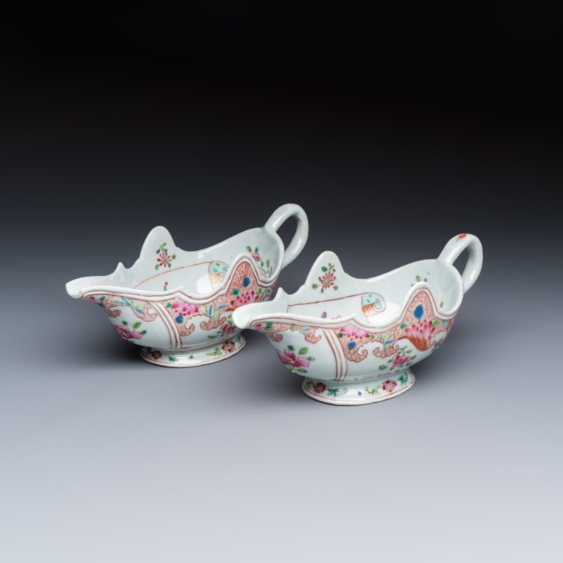 A pair of Chinese famille rose sauceboats with floral scroll design