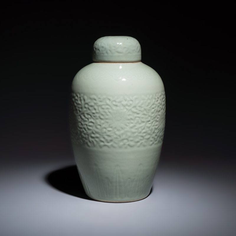 A Chinese celadon-glazed covered vase with floral relief design - 图5