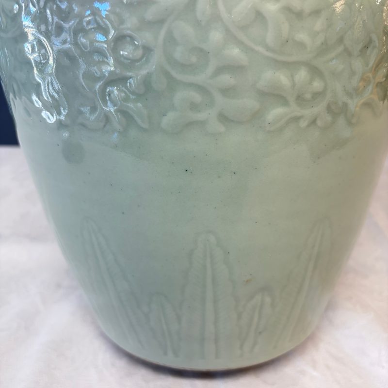 A Chinese celadon-glazed covered vase with floral relief design - 图15