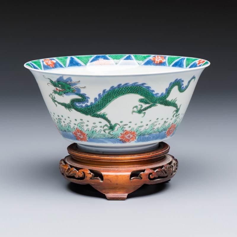 A Chinese famille verte 'Dragon' bowl on a later wooden stand