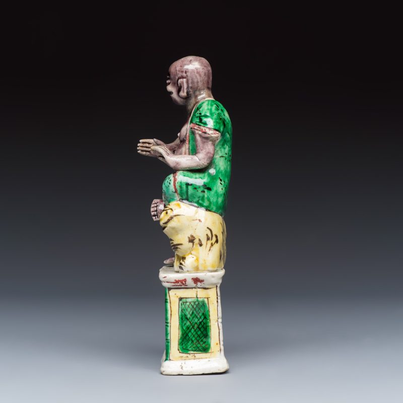 A Chinese famille verte sancai biscuit model of a seated Luohan on a tiger - 图3