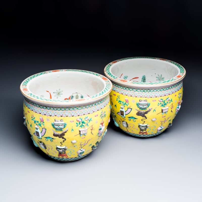 A pair of Chinese famille rose yellow-ground 'Antiquities' fish bowls with applied relief design