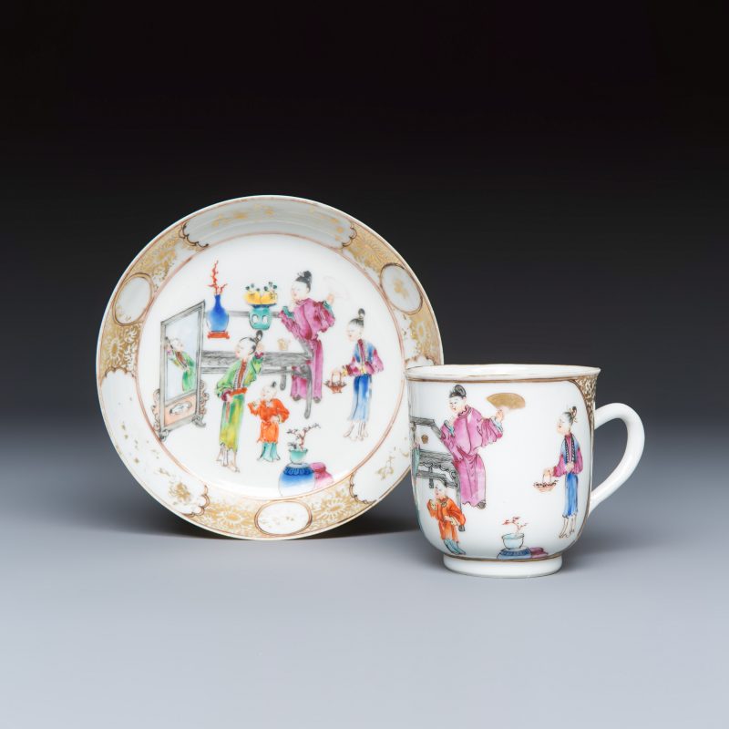 A Chinese famille rose gilt-decorated cup and saucer with figural design