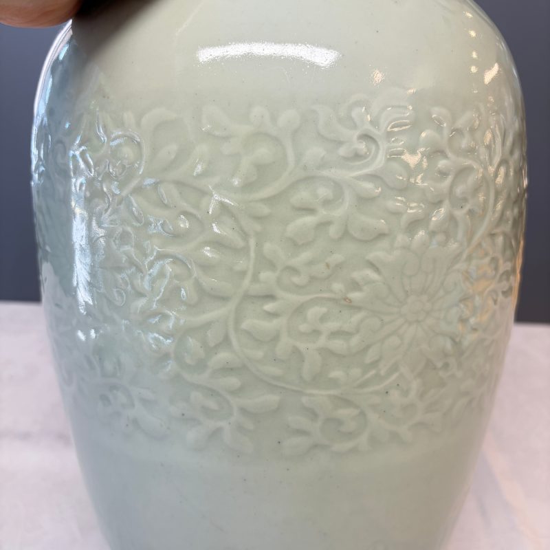 A Chinese celadon-glazed covered vase with floral relief design - 图16