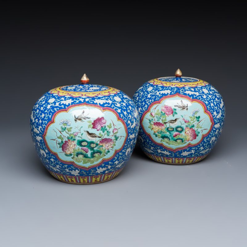 A pair of Chinese famille rose 'Birds among Flowering Branches' jars and covers