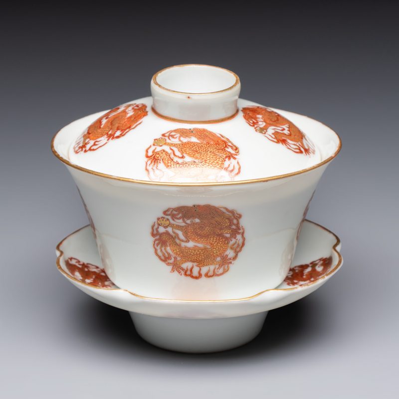 A fine Chinese iron-red and gilt-decorated 'Dragon' covered tea bowl with stand