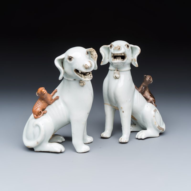 A pair of Chinese export white-glazed and biscuit models of hounds with pups