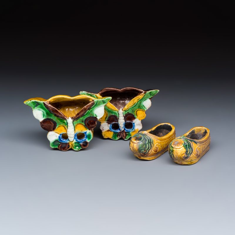 A pair of Chinese famille verte sancai biscuit 'Butterfly' water pots and a pair of shoes