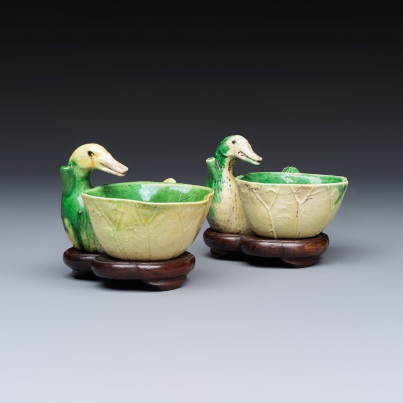 A pair of Chinese famille verte sancai biscuit duck-and-lotus-form water droppers on later wooden stands - 图1