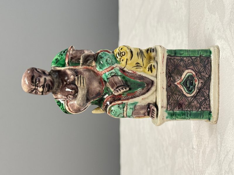 A Chinese famille verte sancai biscuit model of a seated Luohan on a tiger - 图8