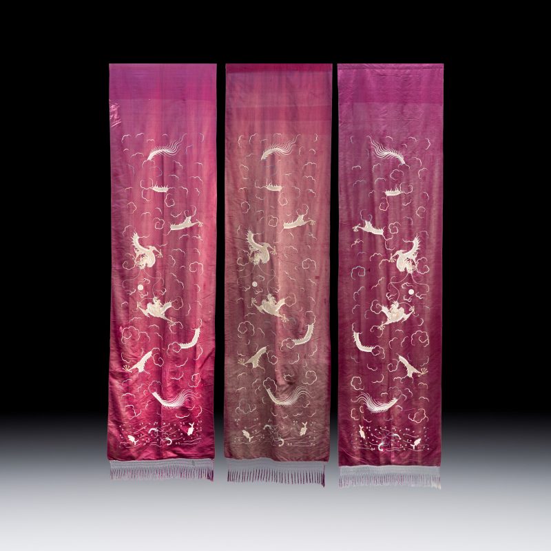 Three large Vietnamese purple-ground embroidered silk 'Dragons among Clouds' panels