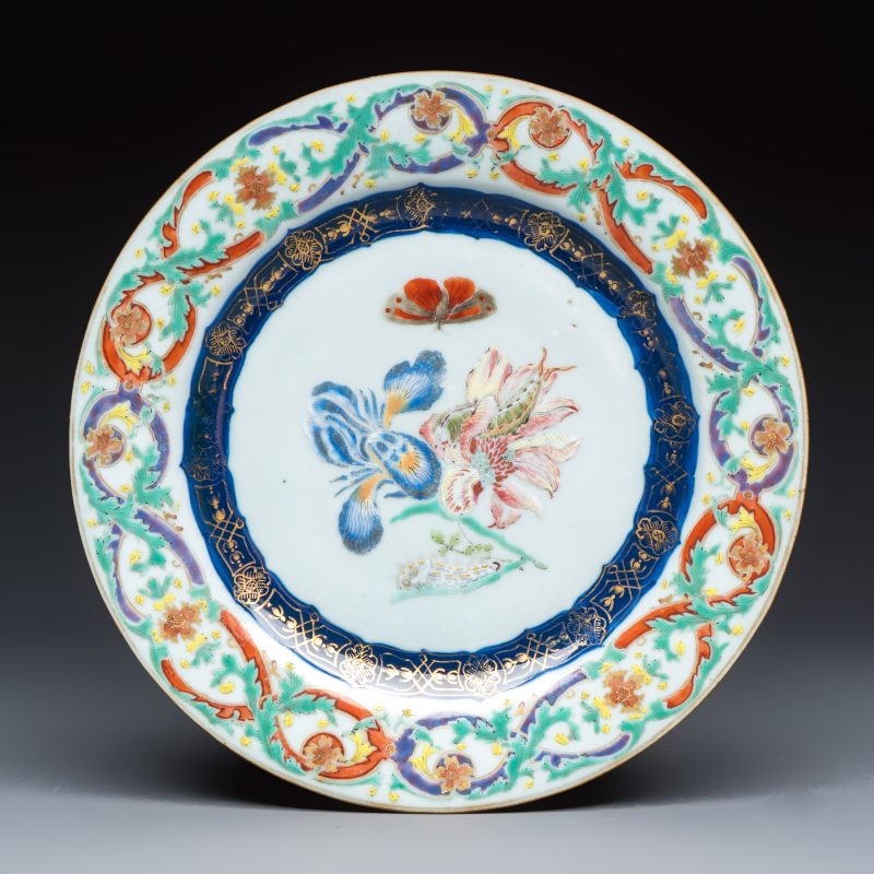 A Chinese famille rose 'Botanical' plate based on designs by the German botanist Maria Sybille Merian