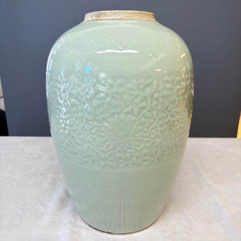 A Chinese celadon-glazed covered vase with floral relief design - 图10