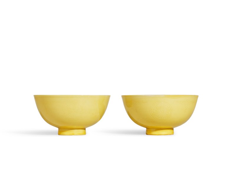 A fine pair of incised yellow-glazed ‘floral medallion’ bowls, Marks and period of Kangxi | 清康熙　黃釉刻團花紋盌一對　《大清康熙年製》款