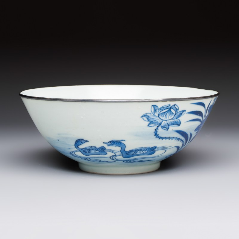 A Chinese blue and white 'Bleu de Hue' bowl with mandarin ducks in a lotus pond and a poem