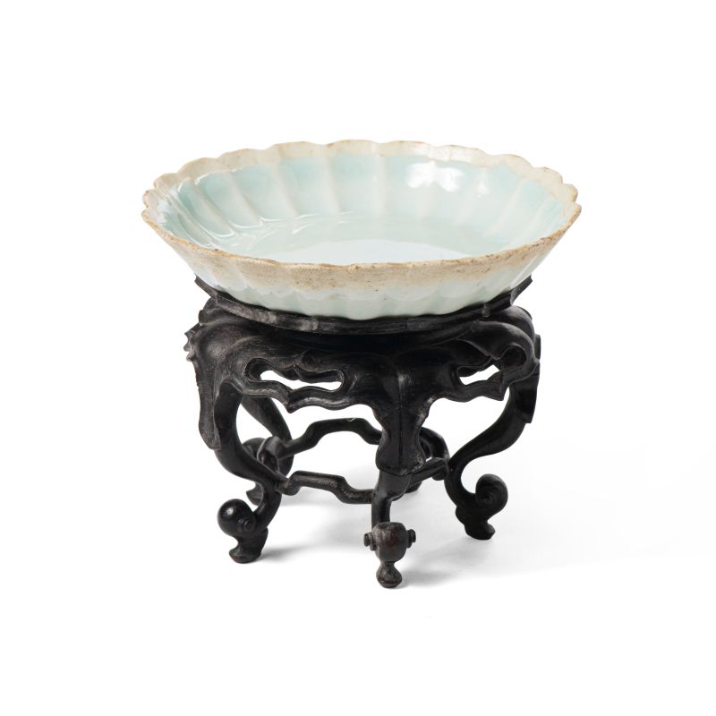 A Qingbai-glazed dish on wooden stand