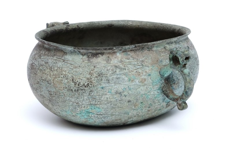 An archaic bronze oval cup with ring handles, He