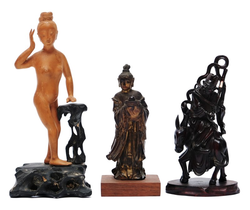 Three small figures including a Guanyin