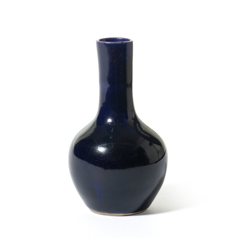 A small aubergine-glazed bottle vase