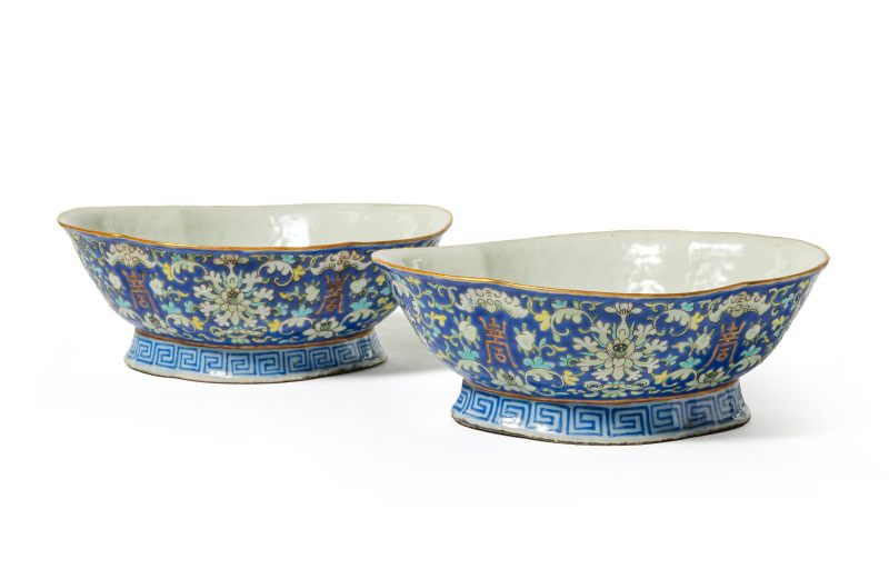 A pair of blue-ground famille rose 'lotus, bat and shou' lobed bowls on foot