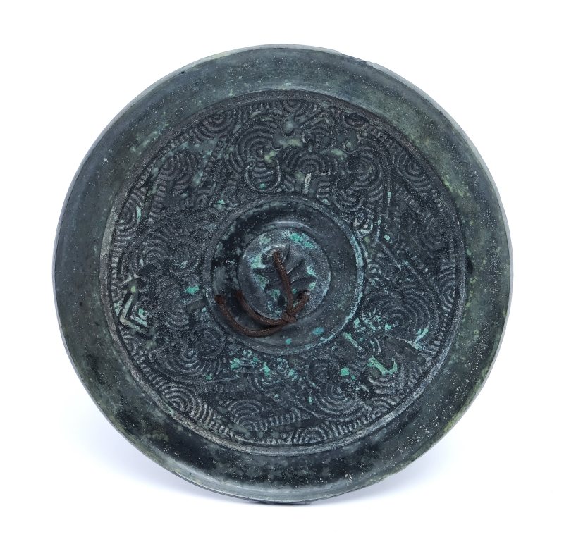 A small bronze mirror with incised decoration